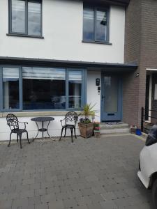 a patio with two chairs and a table in front of a building at Dunfolan House in Dundrum