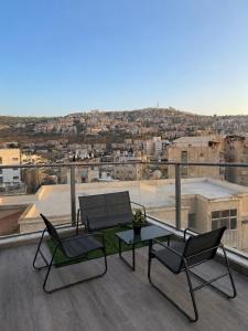 a patio with a table and chairs on a roof at Kinneret Royal Penthouse in Tiberias