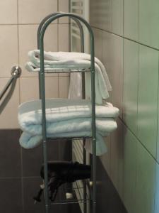 a stack of towels on a towel rack in a bathroom at L'affable Les cammazes in Les Cammazes +63 photos