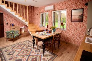 a dining room with a table and a staircase at Dom pod Niebem in Lucimia