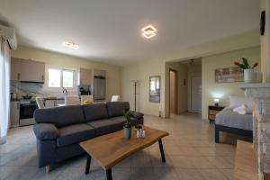 a living room with a couch and a table at Anima Horizon-Petra Apartment in Elaiófiton