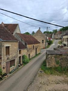 an empty street in a village with stone houses at Le refuge des Champeaux in Domecy-sur-le-Vault