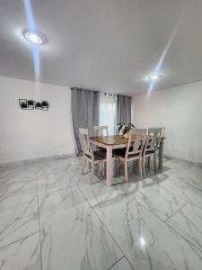 a dining room with a table and chairs on a marble floor at Trajineras xochimilco in Mexico City +3 photos
