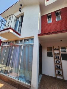 a house with a red roof and a balcony at Trajineras xochimilco in Mexico City