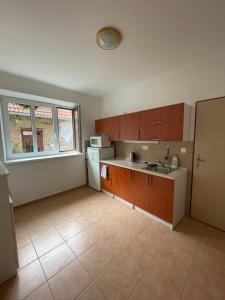 an empty kitchen with a sink and a refrigerator at Leon in Lomnice nad Lužnicí