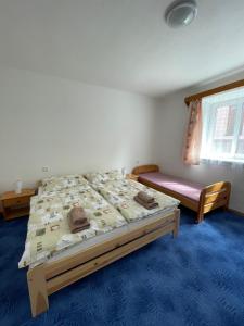 a bedroom with a large bed and a window at Leon in Lomnice nad Lužnicí +14 photos