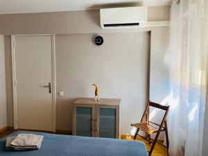 a bedroom with a blue bed and a chair at Blue Riviera in Roquebrune-Cap-Martin