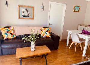 a living room with a couch and a table at Blue Riviera in Roquebrune-Cap-Martin