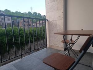 a table and a chair on a balcony at Apartment in Verin Apart hotel in Dilijan in Dilijan