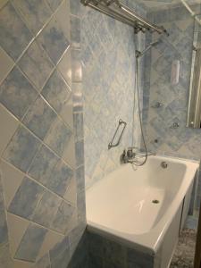 a bathroom with a bath tub and a sink at Український Театр 2-х кімнатні Апартаменти in Odesa +3 photos