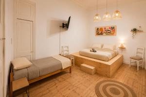 a bedroom with two beds and a table at Silvestre Hostel in Pichilemu +12 photos