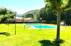 a park with a volley ball court in the grass at El Rincón de María II in Torrecilla en Cameros