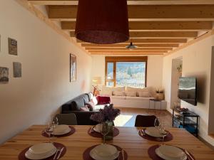 a living room with a table and a couch at El Rincón de María II in Torrecilla en Cameros