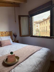 a plate on top of a bed with a window at El Rincón de María II in Torrecilla en Cameros +39 photos