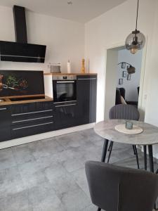 a kitchen with a table and a dining room at Ferienwohnung III in Eisenhüttenstadt