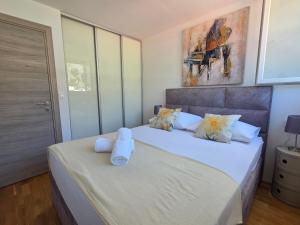 a bedroom with two beds with towels on them at Apartment Maris in Omiš