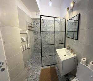 a bathroom with a shower and a toilet and a sink at Happy Studio 1 in Craiova