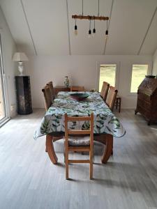 a dining room with a table and chairs and a room with at La Châtelaine in Lombez