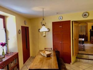 a living room with a table and a dining room at Les volets bleus in Gresse-en-Vercors