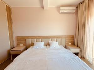 a bedroom with a bed with two white pillows at Skyline View Apt & Sea View Terrace in Budva