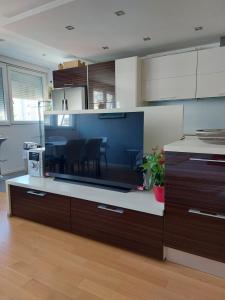 a kitchen with a large counter with a dining room at Apartment Maris in Omiš