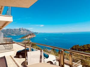 a balcony with a view of the ocean at Skyline View Apt & Sea View Terrace in Budva