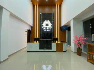 a lobby of a hotel with a sign on the wall at Aisyi Tower Klaten in Klaten +38 photos