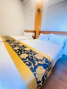 two beds sitting next to each other in a room at Minh Thư Phú Mỹ Hotel in Phú Mỹ