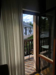 a sliding glass door with a view of a balcony at Apartmani Jasika Zlatar in Nova Varoš