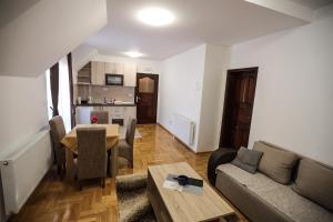 a living room with a couch and a table at Apartmani Jasika Zlatar in Nova Varoš