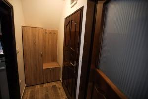 a hallway with a door and a wooden cabinet at Apartmani Jasika Zlatar in Nova Varoš +13 photos