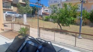 a bag is sitting on the side of a fence at Barefoot Nest in Nea Skioni +27 photos