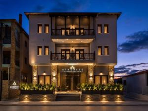 a large white building with lights in front of it at ATHONITE all seasons luxury suites in Ierissos