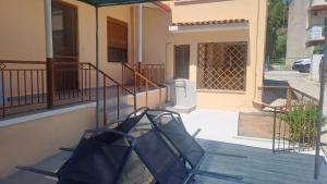 a chair on a porch of a house at Barefoot Nest in Nea Skioni