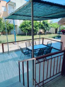 a patio with a table and chairs under a canopy at Barefoot Nest in Nea Skioni