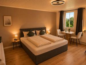 a bedroom with a bed and a table and chairs at Hotel NeckarOase in Lauffen am Neckar +38 photos