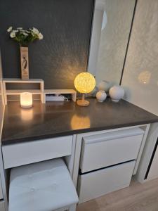 a desk with a lamp on top of it at 여유스테이 2호점 in Suwon