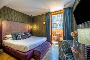 a hotel room with a bed and a window at Hotel Duomo Firenze in Florence +268 photos
