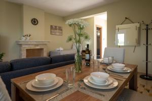 a living room with a table with plates and bowls at Anima Horizon - Terra apartment in Elaiófiton