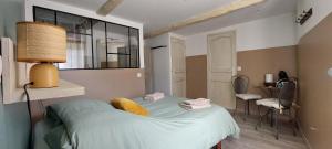 a bedroom with a bed and a mirror on the wall at La Fischaumière in Soleilhas
