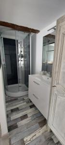 a bathroom with a tub and a sink and a mirror at La Fischaumière in Soleilhas