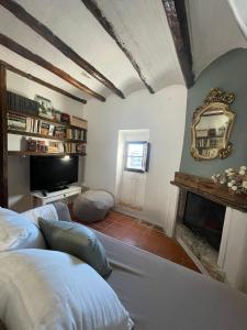 a bedroom with a fireplace and a mirror on the wall at Ca'n Baster 1878 in Juncosa +3 photos