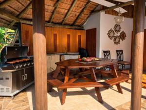 a kitchen and dining room with a table and a grill at Duco self-catering in Nelspruit