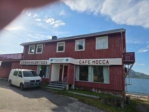 a white van parked in front of a red building at Grønningbrygga in Grønning +2 photos