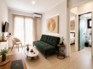 a living room with a green couch in a room at ATHONITE all seasons luxury suites in Ierissos