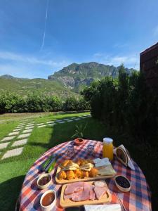 a picnic table with a plate of food on a blanket at Dalmace Villas in Koman