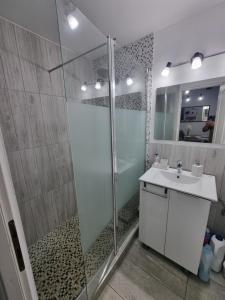 a bathroom with a glass shower and a sink at Cozy Lake House in Cinciş +37 photos