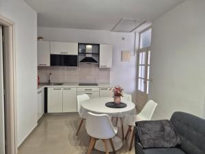 a kitchen and dining room with a table and chairs at Apartments Lenka in Orebić