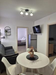 a living room with a table and a couch at Apartments Lenka in Orebić