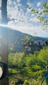 a view of a house in a field with trees at Falak Stays in Shamshi